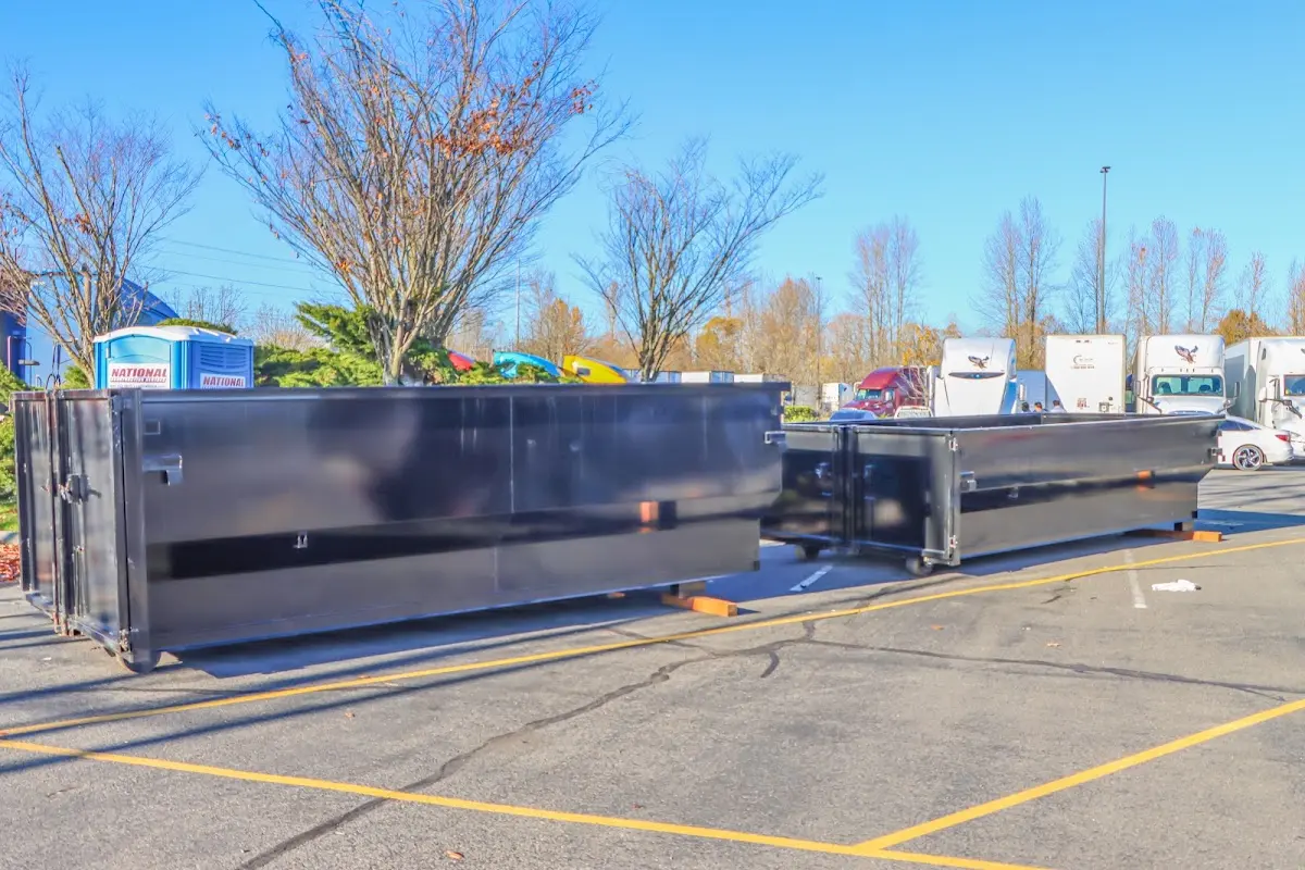 Professional dumpster rental service with roll-off container on residential driveway in Firebaugh